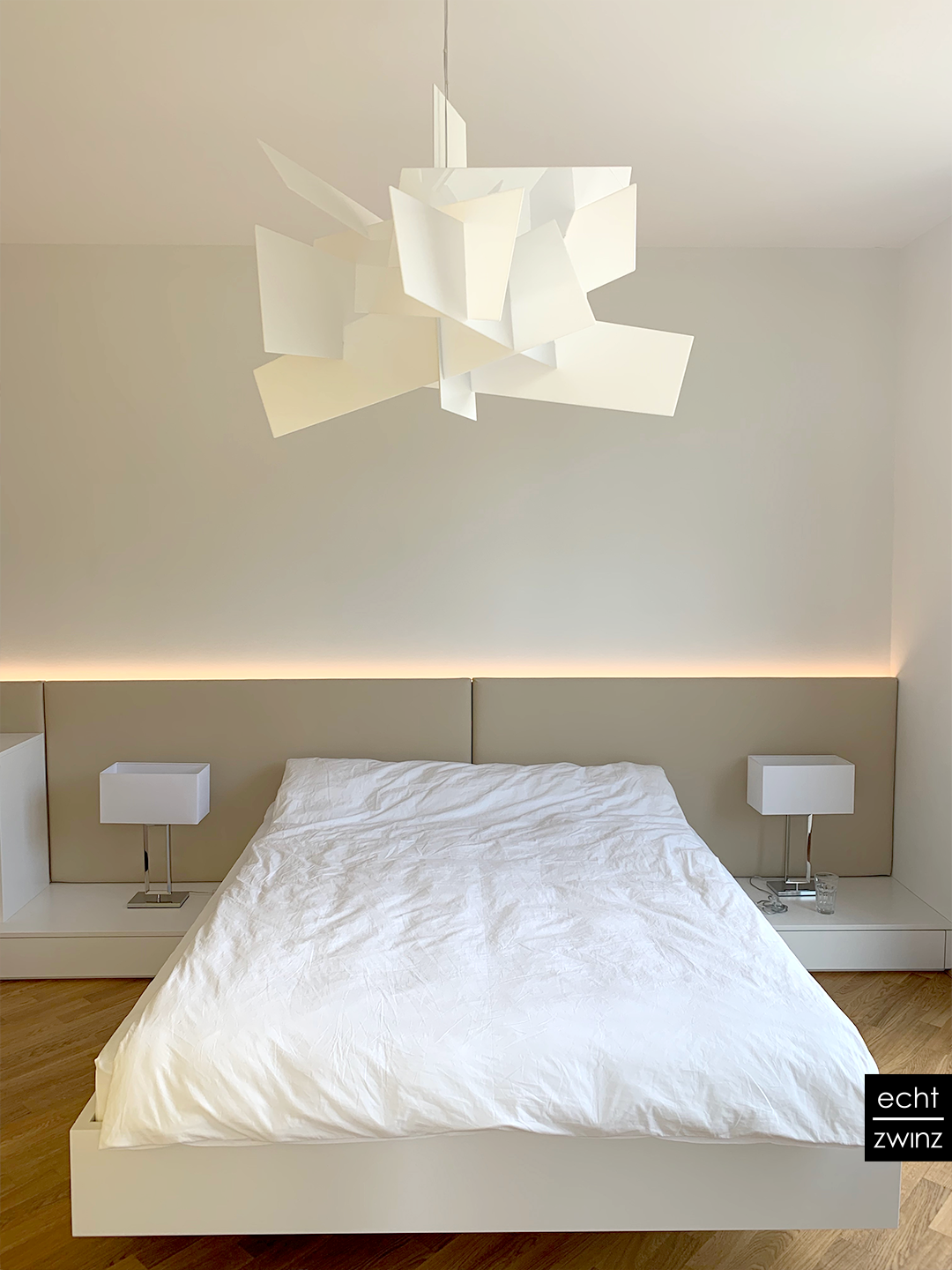 Weißes Schlafzimmer mit schwebendem Bett und Abstrakter Wolkenlampe